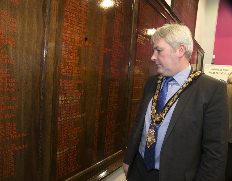 The Mayor of Causeway Coast and Glens Borough Council Councillor Richard Holmes reads some of the names remembered on the War Memorial Boards which are now on display in Roe Valley Arts and Cultural Centre.