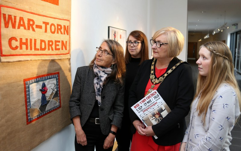 The Mayor of Causeway Coast and Glens Borough Council Councillor Brenda Chivers views the War-Torn Children exhibition with curator Roberta Bacic and Sarah Carson and Jamie Austin from Council's Museums Service.