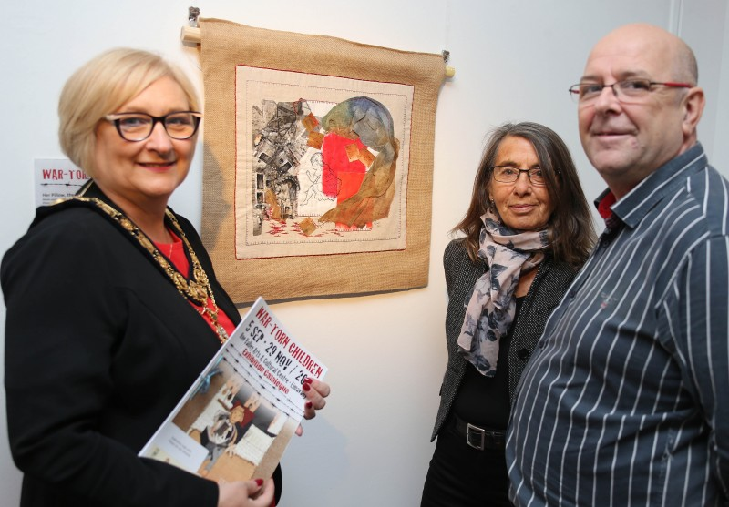 The Mayor of Causeway Coast and Glens Borough Council Councillor Brenda Chivers pictured with the War-Torn Children exhibition curator Roberta Bacic and Billy Coyles from Roe Valley Arts and Cultural Centre.