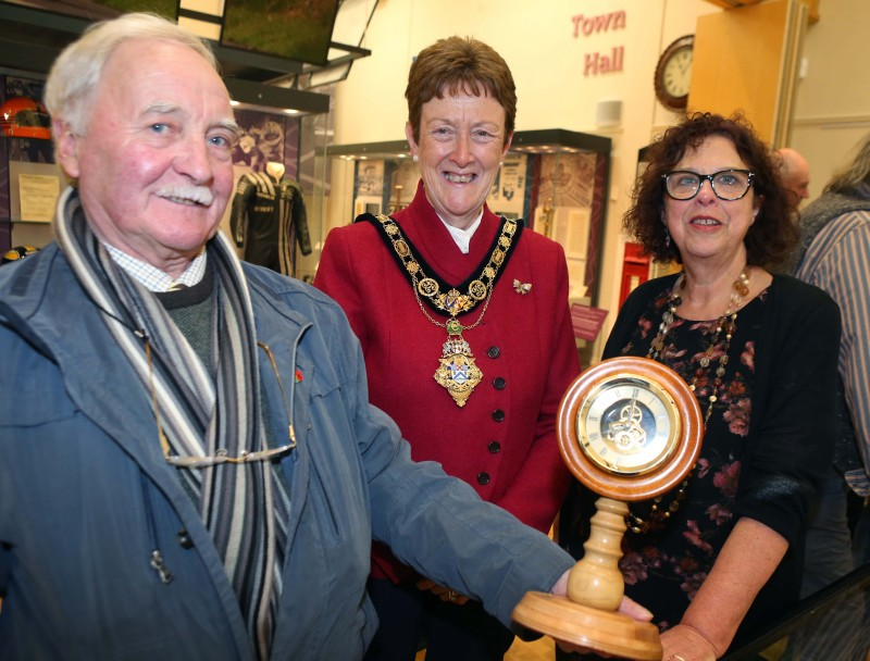 Ken Weir, with his handmade wooden clock, pictured with the Mayor of Causeway Coast and Glens Borough Council, Councillor Joan Baird OBE, and Helen Perry, Causeway Coast and Glens Borough Council Museum Services Development Manager.
