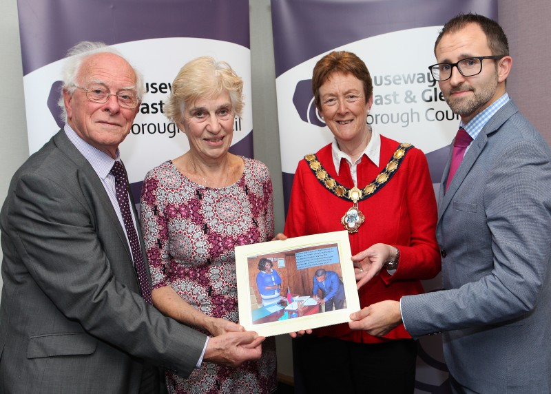 Reverend Terry McMullan, Joyce McMullan, the Mayor of Causeway Coast and Glens Borough Council, Councillor Joan Baird OBE  and Mark Maher from the Northern Ireland Local Government Association (NILGA) with a photograph showing the MOU being signed by representatives of Zomba City Council.