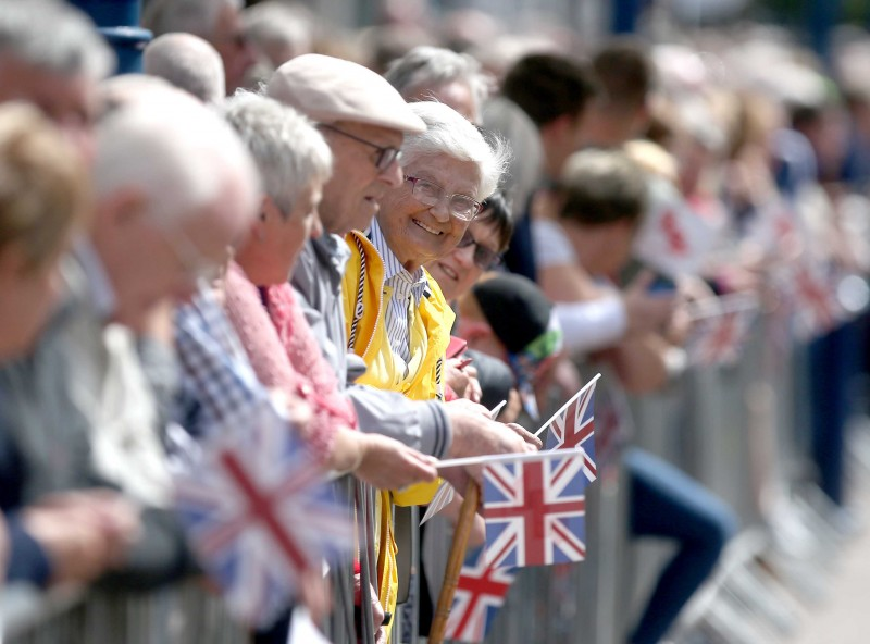 Crowds line the streets to welcome the Armed Forces Day parade.