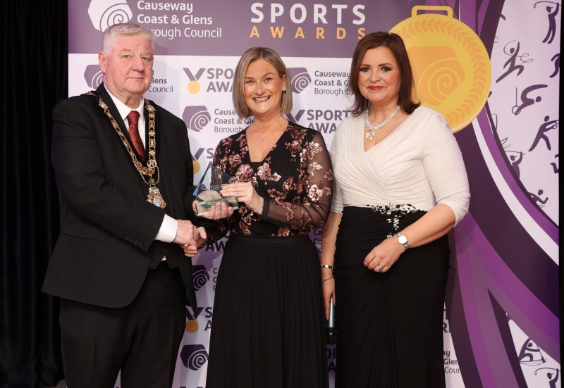Lauren Wade, winner of Sportswoman of the Year, was unable to attend the Sports Awards in person. Her mother, Charlene Wade is pictured accepting the award on her behalf, presented by host Denise Watson and Mayor of Causeway Coast and Glens, Councillor Steven Callaghan.