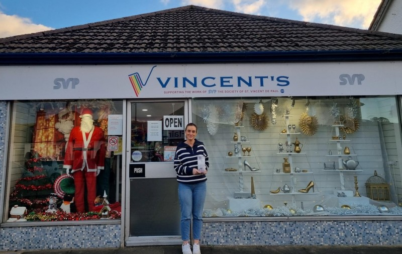 SVP Vincent’s shop volunteer proudly showing off their winning Christmas window design