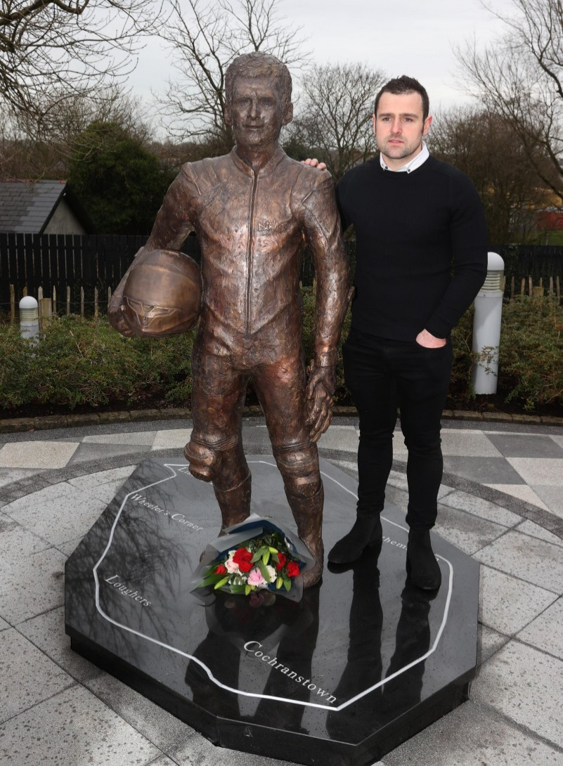 Michael Dunlop stands alongside the new statue of his brother William at the Dunlop Memorial Gardens in Ballymoney.