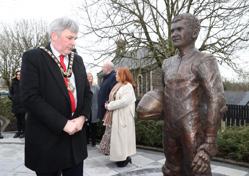 The Mayor of Causeway Coast and Glens Borough Council Councillor Richard Holmes admires the new statue of William Dunlop which has been unveiled at the Dunlop Memorial Gardens in Ballymoney.