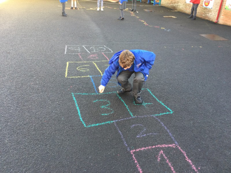 Preparing a game of hopscotch at Macosquin Primary School as part of the Heritage Games organized by Causeway Coast and Glens Borough Council.