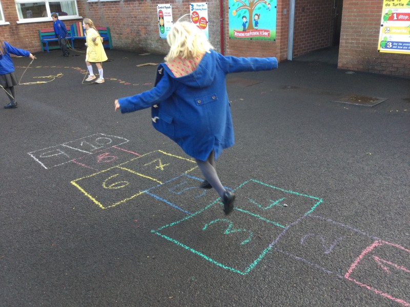 Enjoying a game of hopscotch at Macosquin Primary School as part of the Heritage Games organized by Causeway Coast and Glens Borough Council.