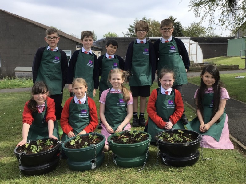 Pupils from Irish Society Primary School who were involved in Council’s Estates Team venture where local schools helped design and make up hanging baskets for Coleraine’s town centre.