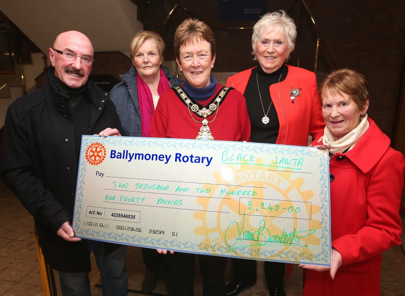 Pamela Esler, Edwina Chambers and Isobel Paul representing the Drop Inn Ministries receive their donation from Ballymoney’s Black Santa Liam Beckett alongside the Mayor of Causeway Coast and Glens Borough Council, Councillor Joan Baird OBE.