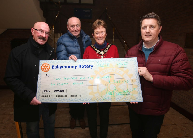 William Fisher and Eugene Wallace from the Society of St Vincent de Paul receive their donation from Ballymoney’s Black Santa Liam Beckett alongside the Mayor of Causeway Coast and Glens Borough Council, Councillor Joan Baird OBE.