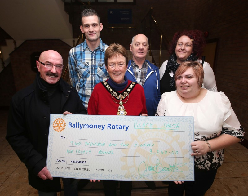 Nigel Campbell , Trevor Purdon, Janet Schofield and Leeanne Gibson from Compass Advocacy Network receive their donation from Ballymoney’s Black Santa Liam Beckett alongside the Mayor of Causeway Coast and Glens Borough Council, Councillor Joan Baird OBE.
