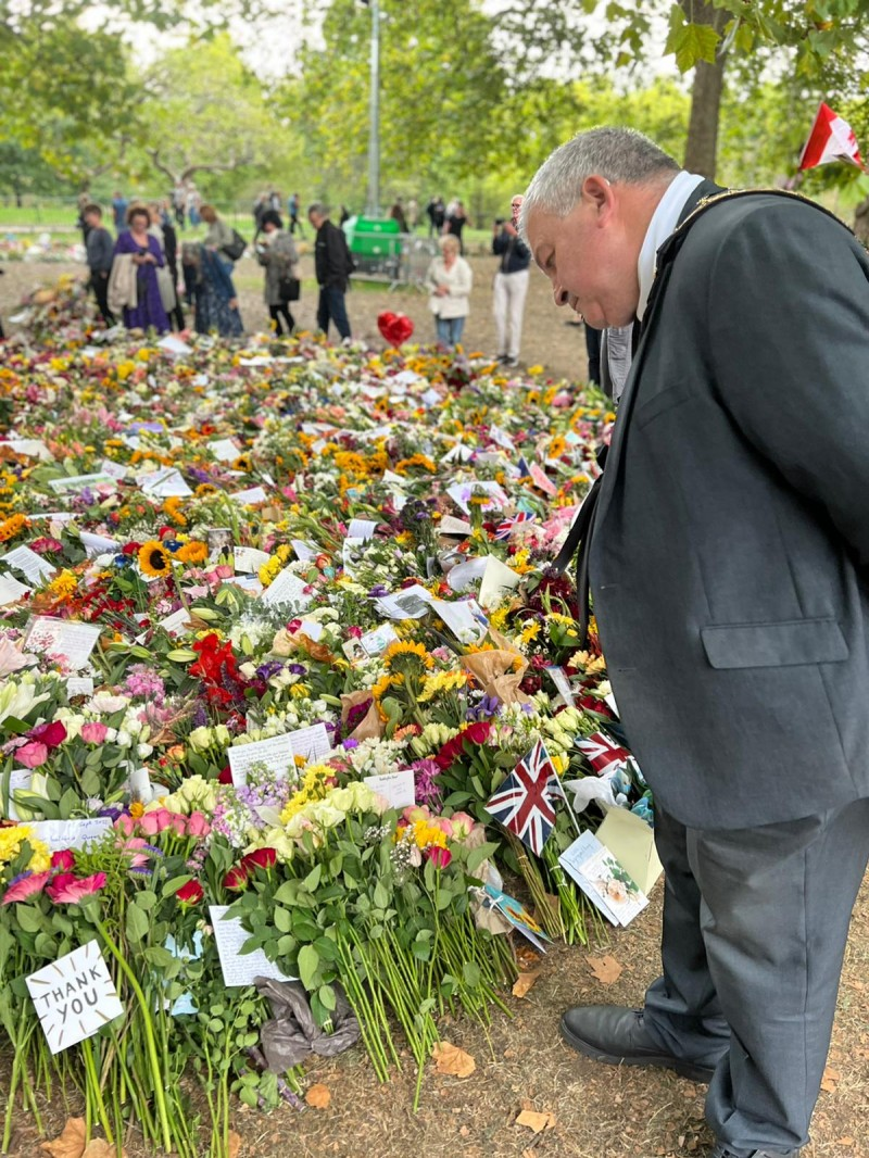 The Mayor of Causeway Coast and Glens Borough Council, Councillor Ivor Wallace, views some of the floral tributes during his trip to London.
