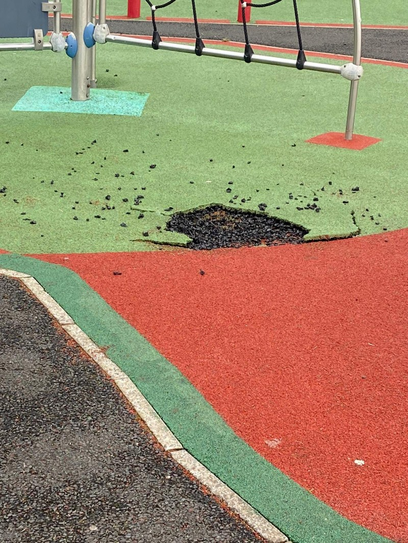 Part of the soft play surface at Millburn Play Park in Coleraine has been ripped away, exposing the rough hard surface below and creating dangerous trip hazards.