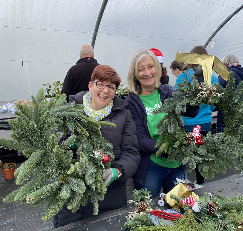 Move More participant Jenny Maginn and Pauline McNeill adding decorations to their Christmas wreaths as part of the Feel-Good Gardening initiative.