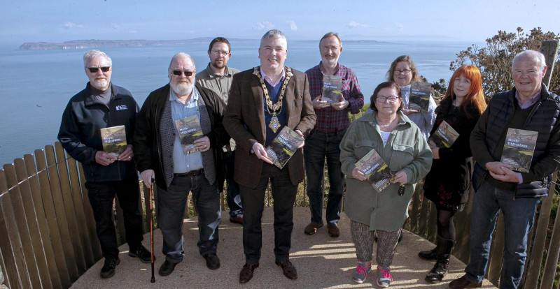 The Mayor of Causeway Coast and Glens Borough Council, Councillor Richard Holmes, pictured with some of the the contributors to the booklet (from left to right): Roger Perritt, Peter Molloy, Nic Wright (Museum Services Community Engagement Officer), Cllr Richard Holmes, Brian Molloy, Brigene Mc Neilly, Geraldine Anslow, Orla Duncan and Donnell O’Loan at Portaneevy Viewpoint looking across the Sea of Moyle to Rathlin Island.
