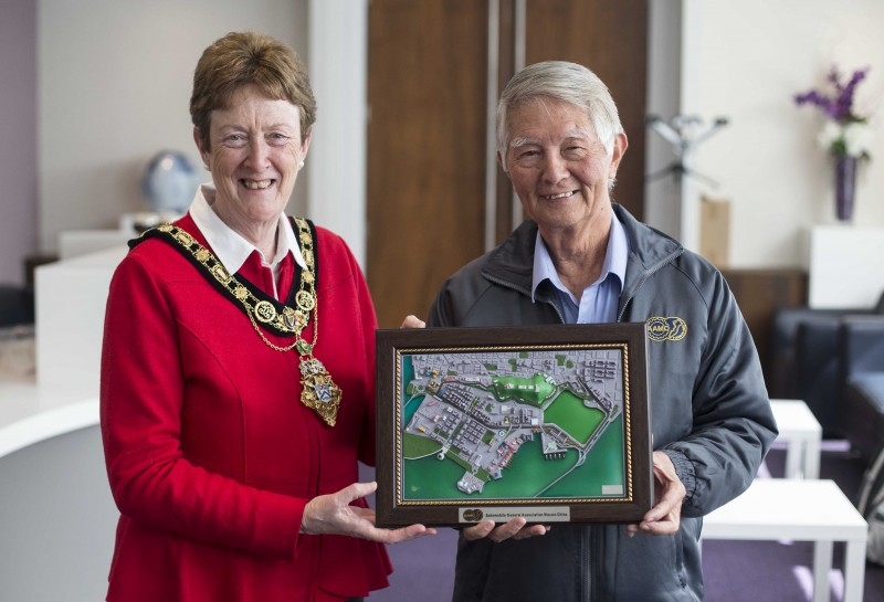 Patrick Castro, Track Manager of Macau Grand Prix, presents a map of the area to the Mayor of Causeway Coast and Glens Borough Council Councillor Joan Baird OBE.