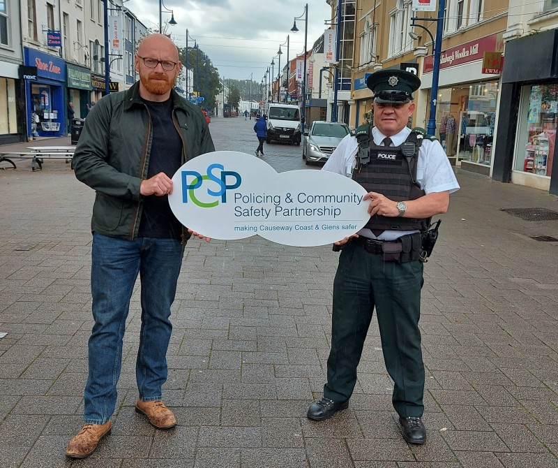 The Chairperson of Causeway Coast and Glens Policing and Community Safety Partnership Councillor Darryl Wilson pictured in Coleraine town centre with Constable Peter Olphert. The PSCP and PSNI are urging the public to be on their guard against High Street Voucher scammers.