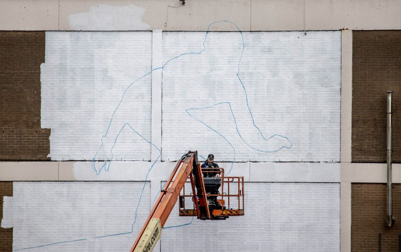 2 A mural of a surfer by artist Aches starts to take shape on a wall overlooking East Strand in Portrush as part of a wider scheme to increase the vibrancy of our town centres.