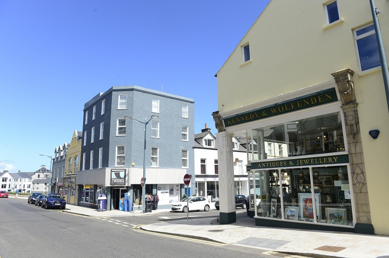 118 businesses in Portrush town centre have received direct investment from the Portrush Regeneration Programme.  Pictured are Troggs and Kennedy & Wolfenden.  Both businesses received revitalise funding to upgrade their shop frontages.  The improvements to the paving on Main Street have also modernised the town.