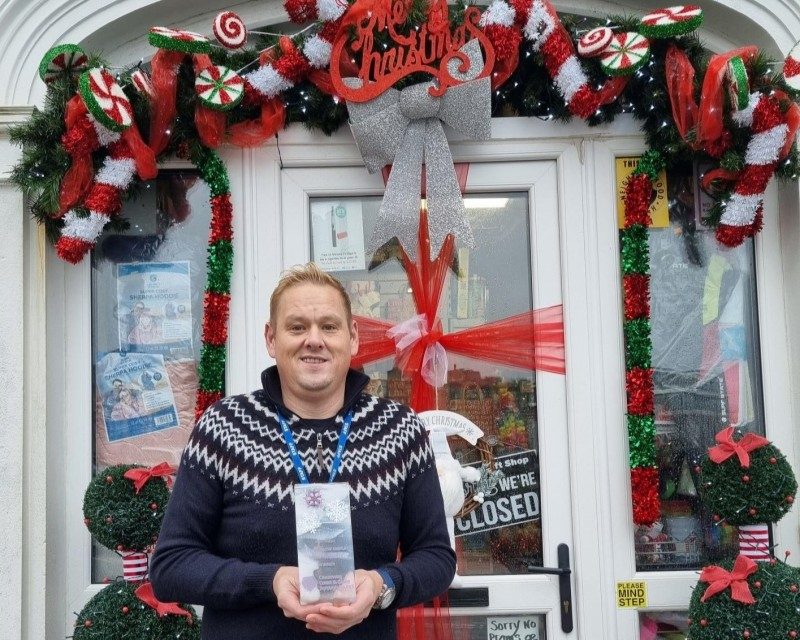 Jasper’s Gift Shop staff member shows off their festive décor