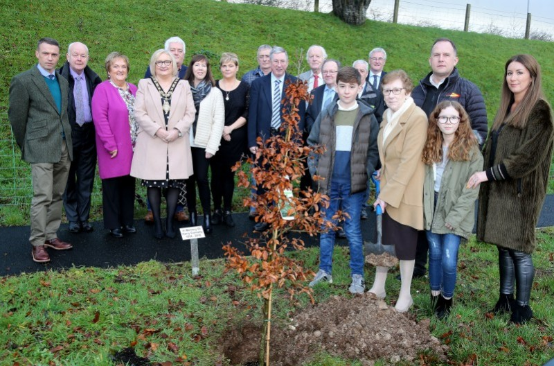 Philomena Connolly plants a tree in memory of her late husband Harry at the official opening of the new Healthy Living Centre and walking path.