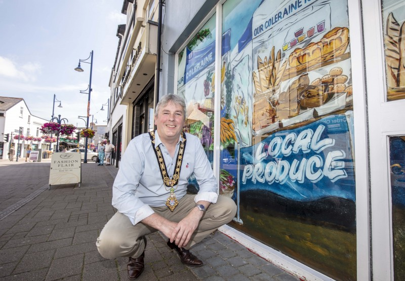The Mayor of Causeway Coast and Glens Borough Council Councillor Richard Holmes pictured during a recent visit to Coleraine town centre to view the shop window artworks created by local artist Mark Christie.