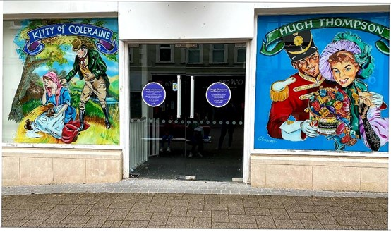These colourful images featuring Kitty of Coleraine and Hugh Thompson are depicted on an empty shop window in Coleraine.