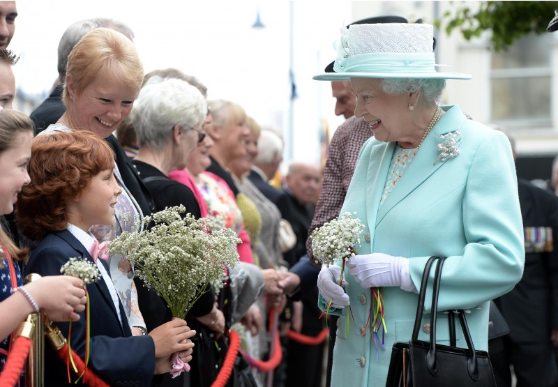 2014, The Queen speaks with a young member of the public during her visit to Coleraine.