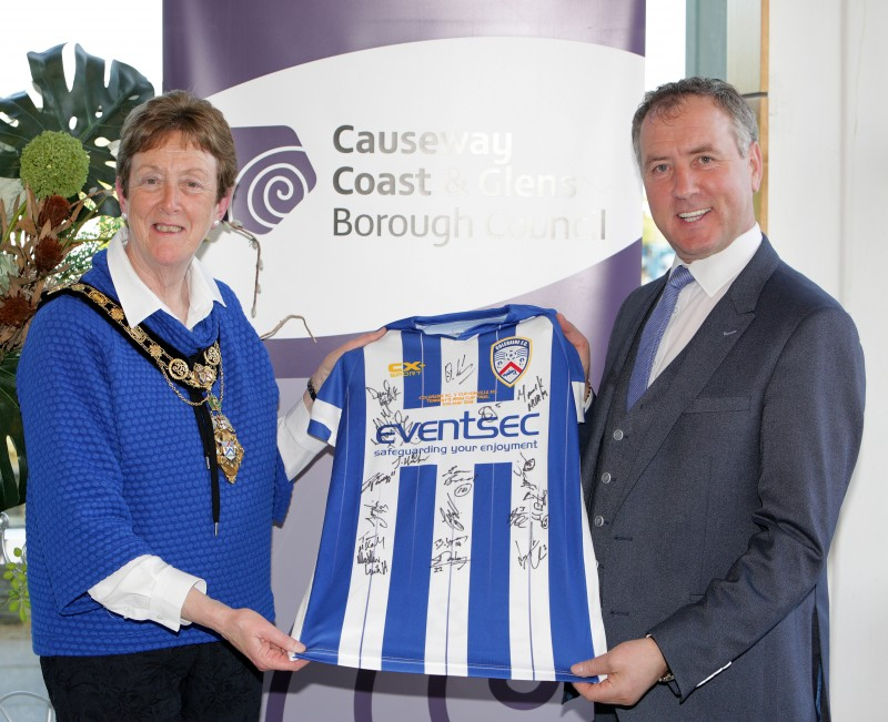 Club Chairman Colin McKendry presents a signed shirt to the Mayor of Causeway Coast and Glens Borough Council Councillor Joan Baird OBE.