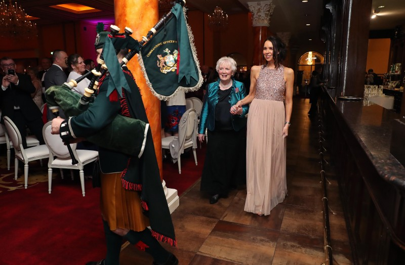 Mrs Joan Christie CVO OBE, accompanied by Councillor Stephanie Quigley and the Pipe Major, makes her entrance at the gala dinner.