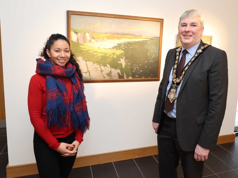 Arts and Culture Facilities Officer Esther Alleyne shows the Mayor of Causeway Coast and Glens Borough Council, Councillor Richard Holmes, around the Causeway Collection 100 exhibition which is on display throughout December at Roe Valley Arts and Cultural Centre.