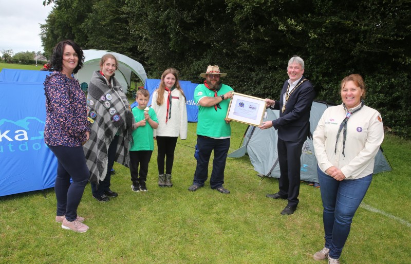 The Mayor of Causeway Coast and Glens Borough Council Councillor Richard Holmes makes a special presentation to Jonny Hoy (Group Scout Leader) alongside Stephanie Meikle (County Commissioner, right), Shauna Tuttey (Chairperson), Robyn Peden, Eve Lynas and Jack Dinsmore to mark 100 years of scouting in Ballymoney.
