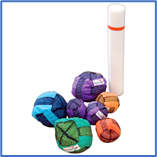 A group of colourful balls next to a white cylinder